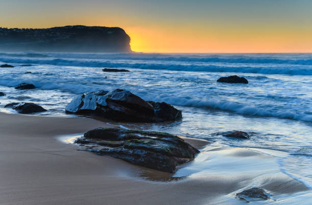istock Sunrise and Rocks at the Beach 1017103268