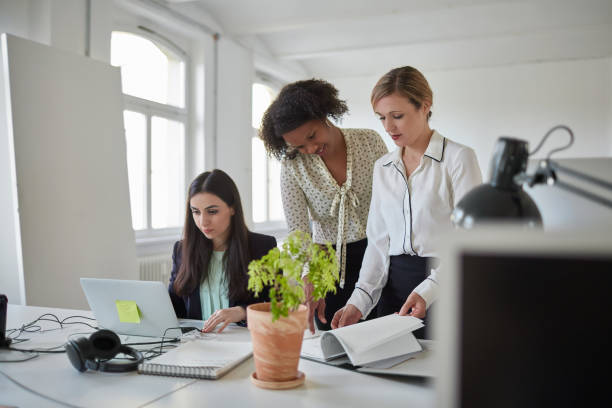 istock Female professionals discussing at office 1017103760