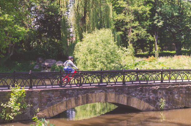 istock Cyclist in helmet riding in park on bridge 1017111090
