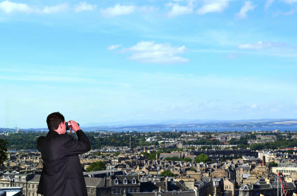 Business Man is spying with Binoculars on Competitors