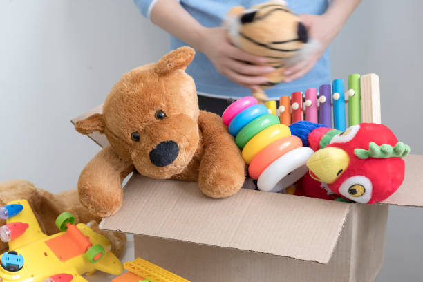 istock volunteer holding donation box with old toys 1017125168