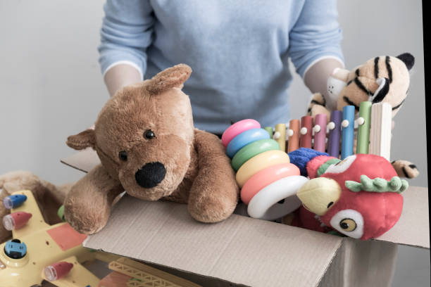 istock volunteer holding donation box with old toys 1017125268