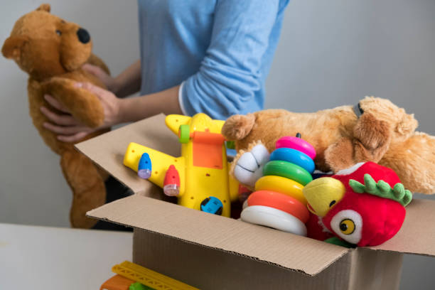 istock volunteer holding donation box with old toys 1017125306