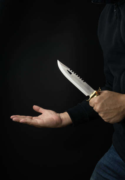 istock a bandit with a combat knife trying to rob victim 1017128304