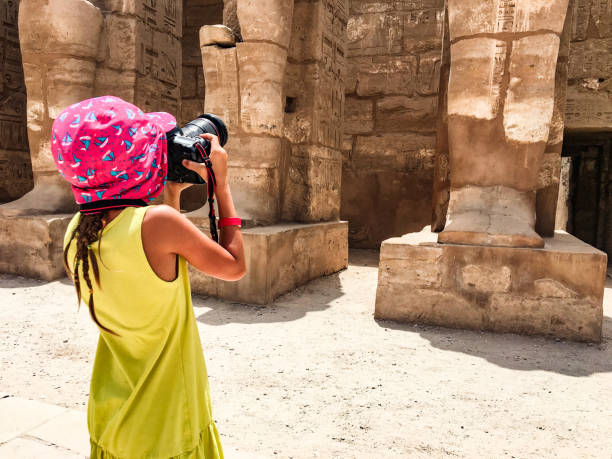 istock Young Girl Photographing Ancient Temple in Egypt 1017144030