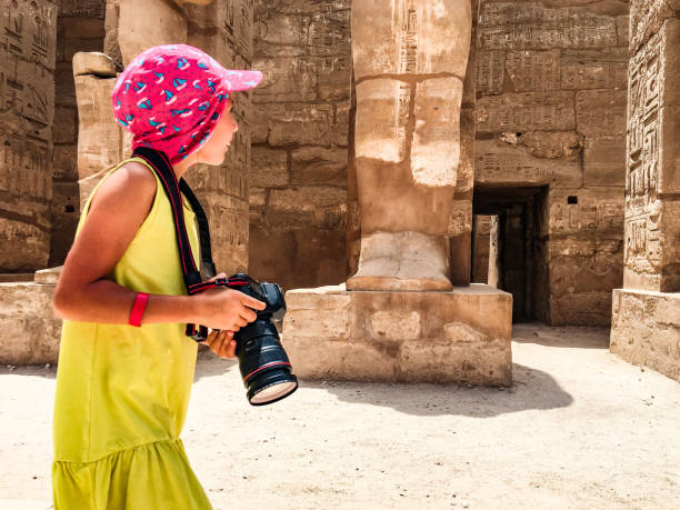 istock Young Girl Photographing Ancient Temple in Egypt 1017144044