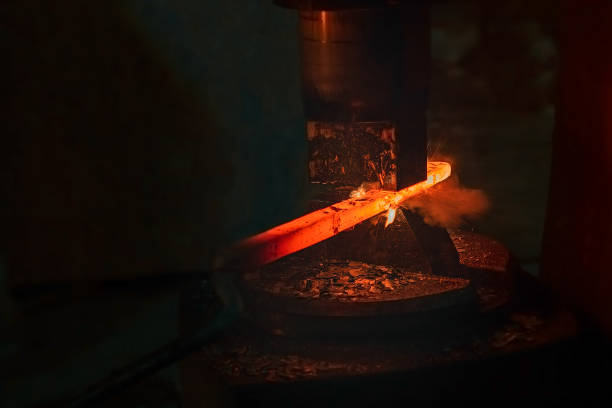 Blacksmith's hammer hits the red-hot iron billet