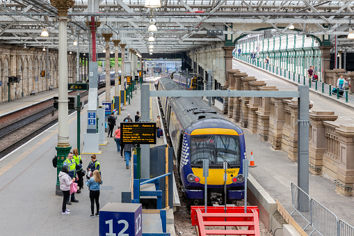 Several trains alongside platforms at the final approach to New Street station in Birmingham, England.