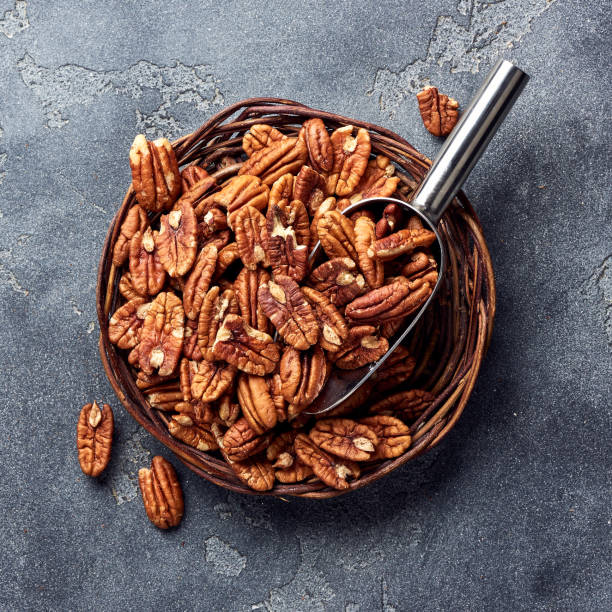istock Pecan nuts and scoop on gray table 1017163332