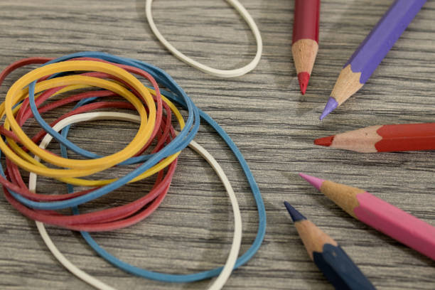 istock Colored pencils and rubber bands on a wood table composition 1017174316