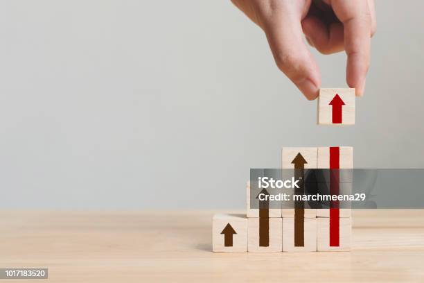 Hand Arranging Wood Block Stacking As Step Stair With Arrow Up Ladder Career Path Concept For Business Growth Success Process Stock Photo - Download Image Now