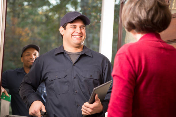 istock Repairmen arrive at customer's front door for home repairs. 1017190120