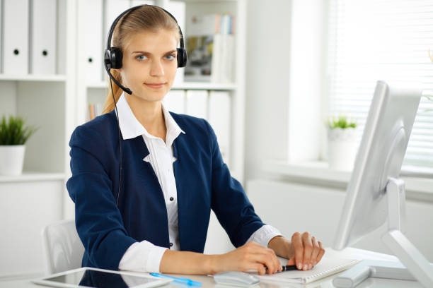 istock Modern business woman with headset in the office. Customer service operator at home work place. Success start up concept 1017190438