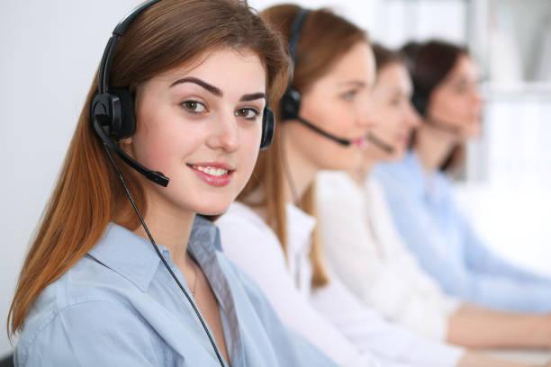 istock Call center. Beautiful cheerful smiling operator consulting clients with headset. Business concept of customer service 1017190536