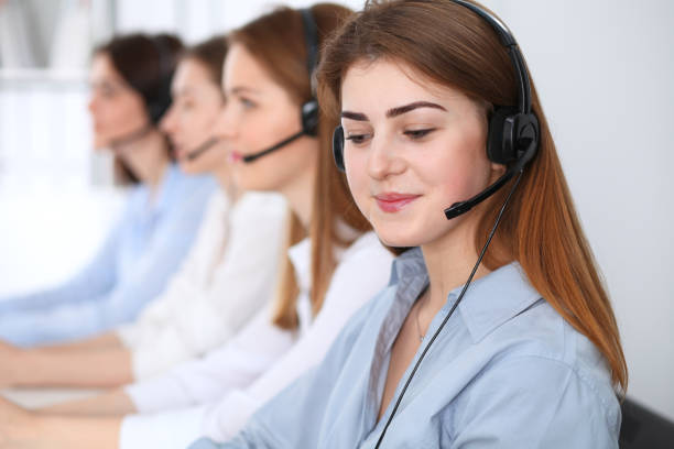 istock Call center. Beautiful cheerful smiling operator consulting clients with headset. Business concept of customer service 1017190592