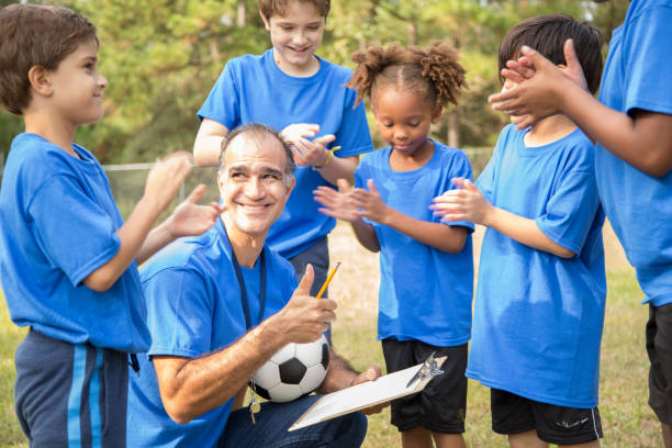 istock Soccer team coach explains next play to his children's team. 1017190832