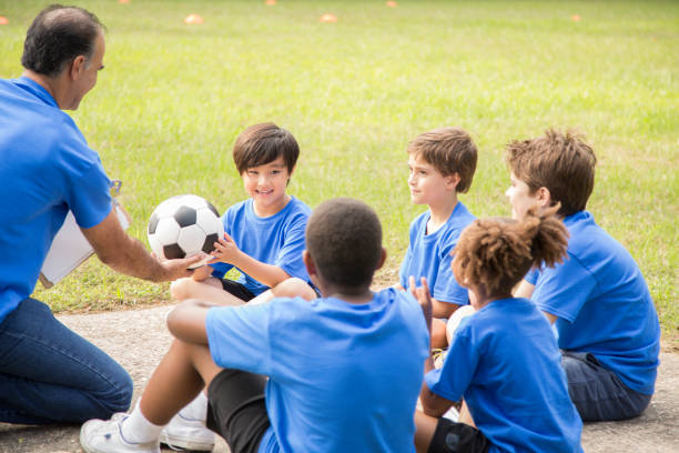 istock Soccer team coach explains next play to his children's team. 1017192872