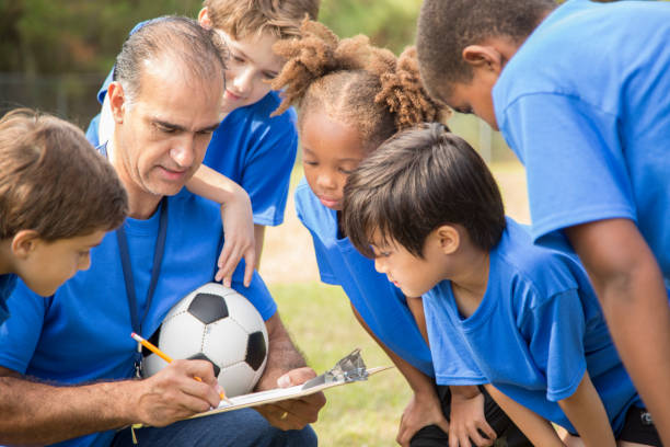 istock Soccer team coach explains next play to his children's team. 1017192892