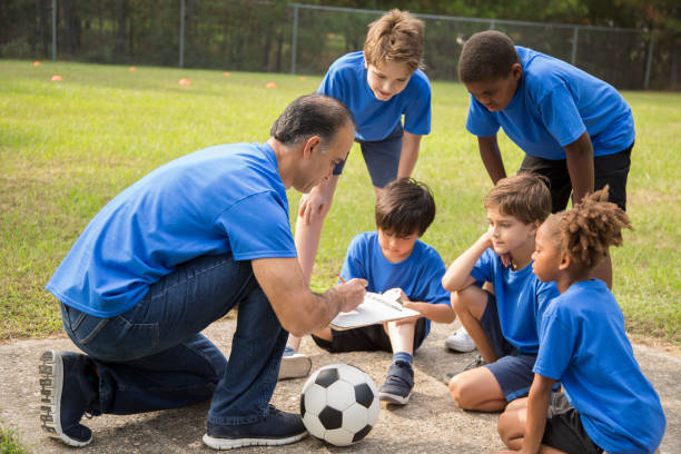 istock Soccer team coach explains next play to his children's team. 1017192898