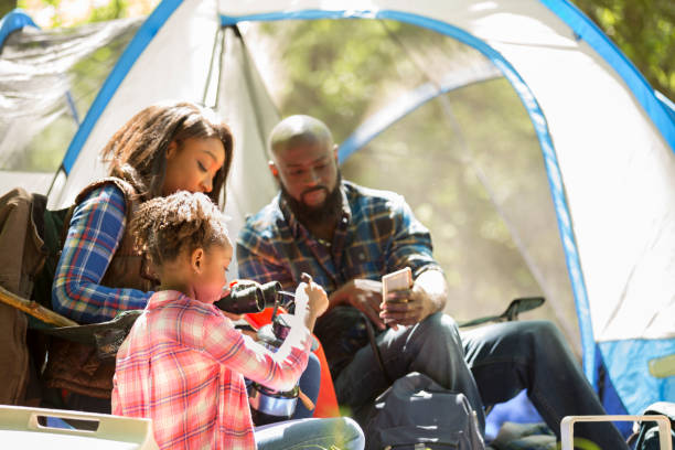 istock Family on summer or autumn vacation camping in forest. 1017193096