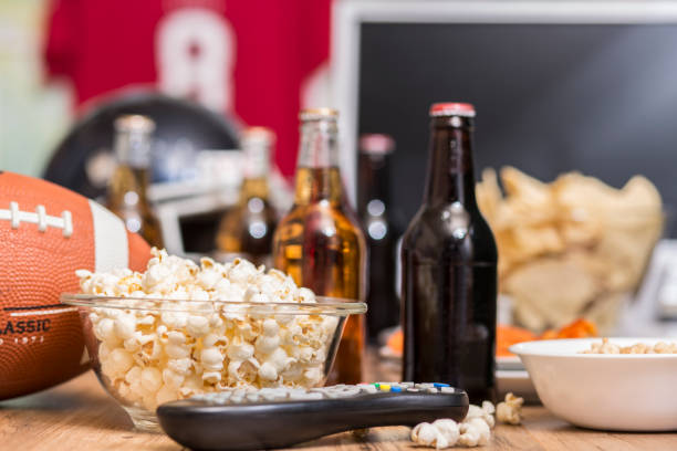 istock Watching the football game with snacks, drinks. 1017196396