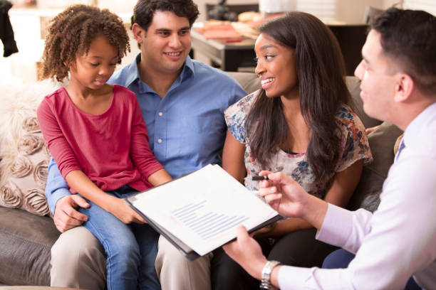istock Multi-ethnic couple meets with financial advisor. 1017196792