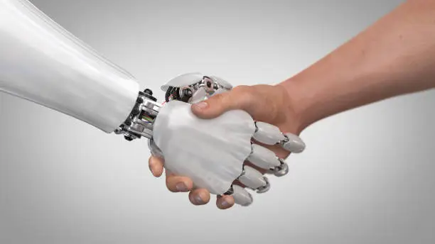 Photo of Robot and Man Shaking Hands