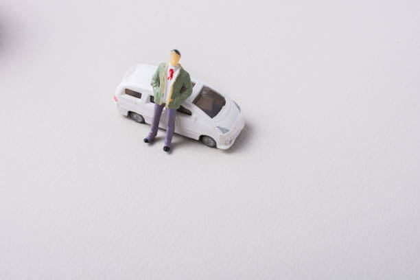 istock Tiny figurine of men in front of a car 1017207574
