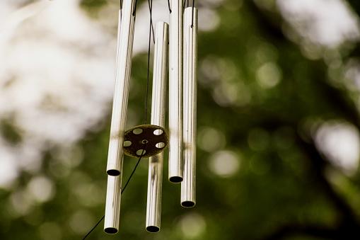 Image of a musical wind metal pipes hanging outdoor