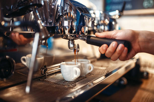 istock Barista hand pours beverage from coffee machine 1017225048