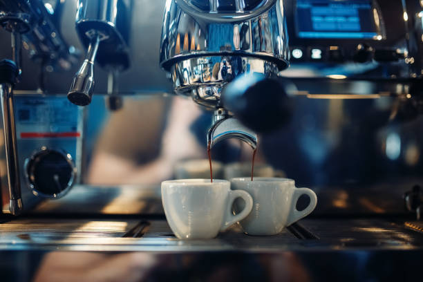 istock Coffee machine pours fresh espresso into the cups 1017225288