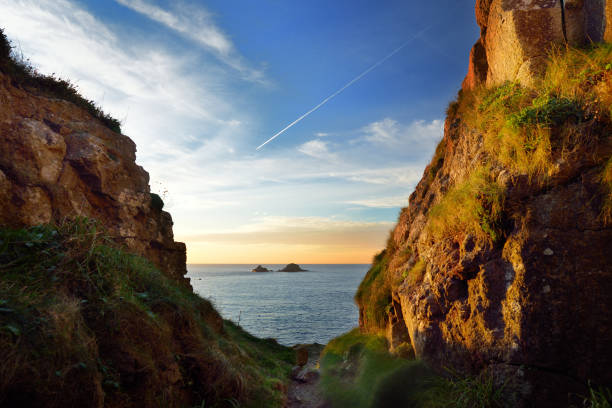 Scenic rugged Cornish coastline at Porth Nanven on sunny evening, Cornwall, England