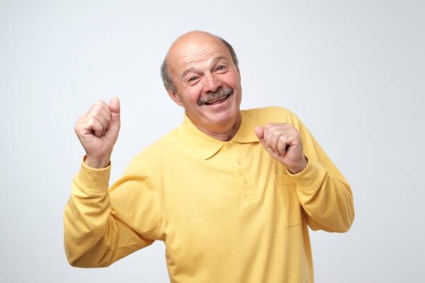 istock Mature happy man moving dancing over white background. 1017236144
