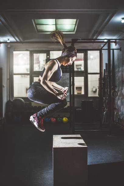 istock Woman doing box jumps at a gym 1017243722