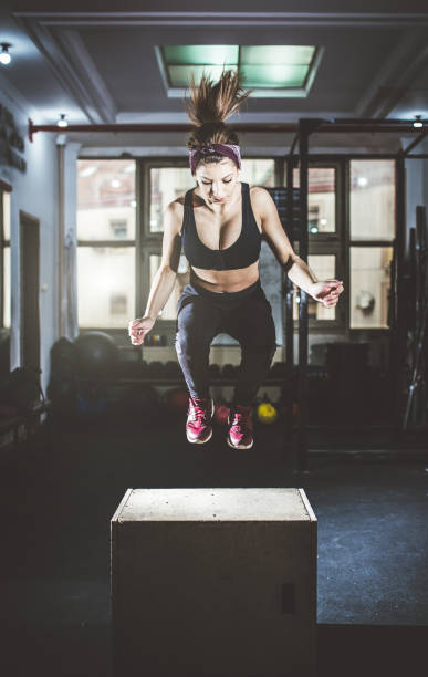 istock Woman doing box jumps at a gym 1017243734