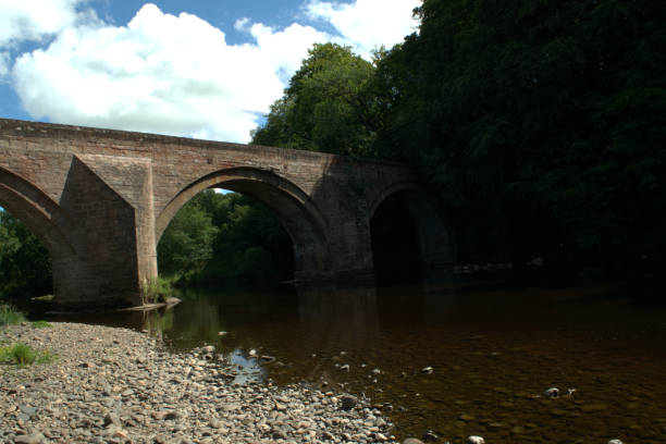 istock Arched stone bridge over River Ayr at Stair, Scotland 1017250896