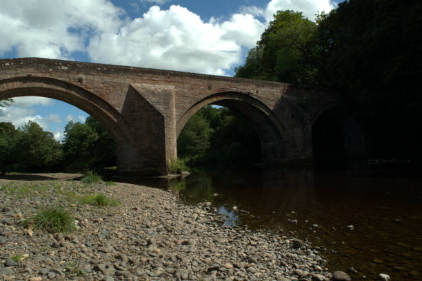 istock Arched stone bridge over River Ayr at Stair, Scotland 1017251100