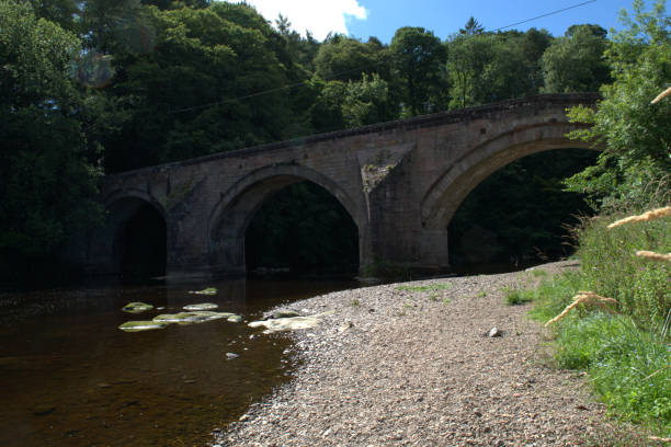 istock Arched stone bridge over River Ayr at Stair, Scotland 1017251238