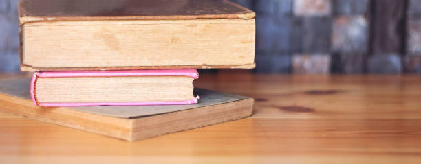istock Work place table with stacks of real books on it as banner 1017261316