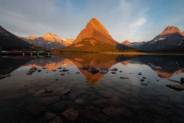 istock Swiftcurrent Lake with Reflection of Mountain Sunrise 1017282370