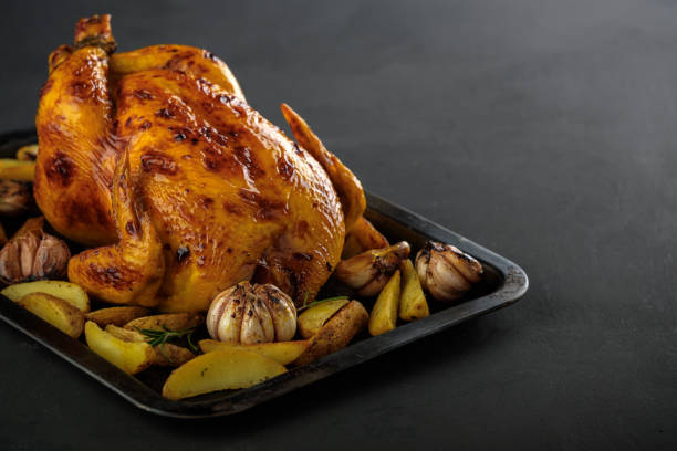 istock Roasted chicken with potatoes on a baking sheet. 1017290126