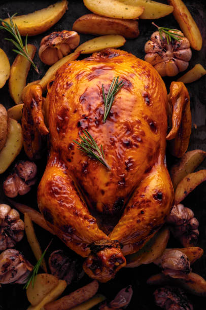 istock Roasted chicken with potatoes and garlic, top view 1017290150