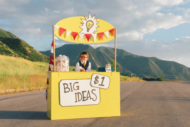 istock Young Business Boy Runs Big Idea Stand 1017294134