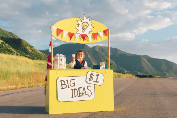 Young Business Boy Runs Big Idea Stand stock photo