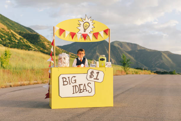 istock Young Business Boy Runs Big Idea Stand 1017294346