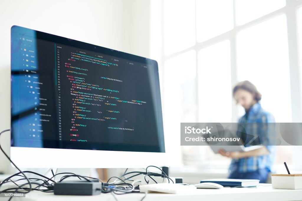 Computer of programmer Coded data on computer screen at workplace of modern programmer networking on background Computer Programmer Stock Photo