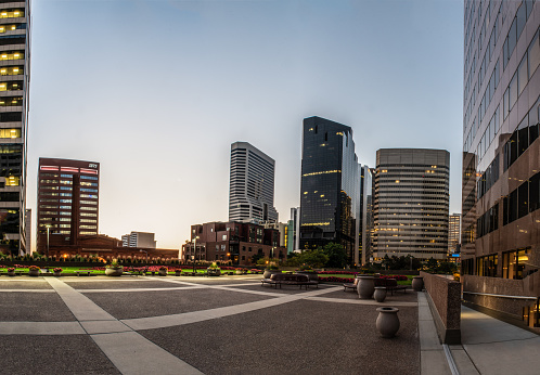 Downtown district of Denver, Colorado showing tall buildings and 2nd floor greenbelt park area on August 9, 2018.