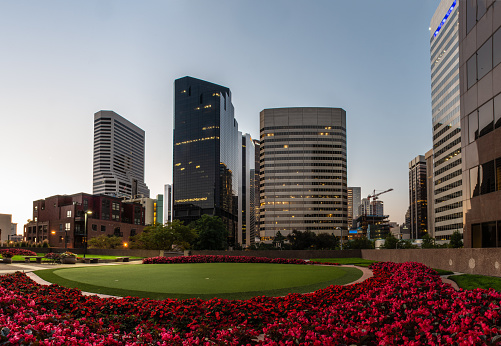 Downtown district of Denver, Colorado showing tall buildings and 2nd floor greenbelt park area with recreational putting green on August 9, 2018.