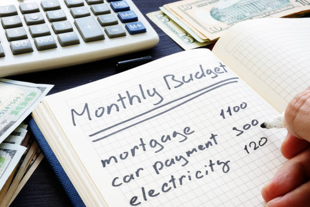 istock Man is writing Monthly Budget Plan. Home finances. 1017299966