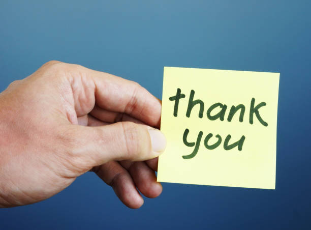 istock Hand is holding memo stick with sign Thank you. 1017300498
